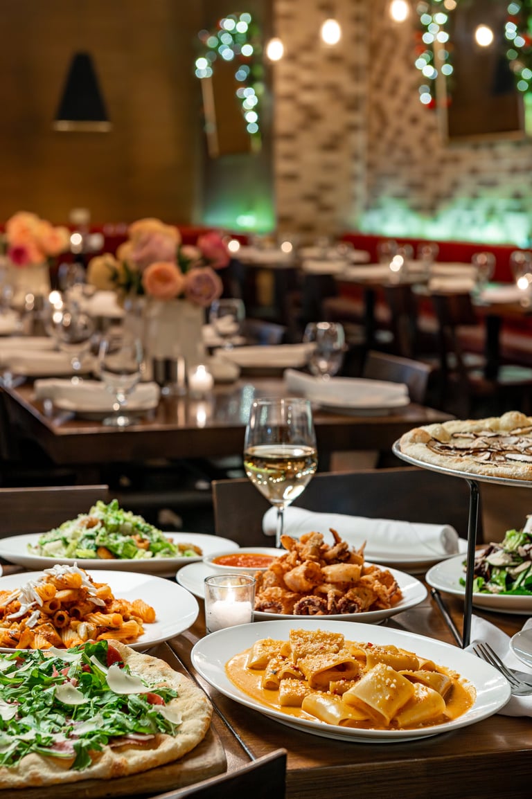 Various dishes served at a restaurant during dinner time with a warm setting
